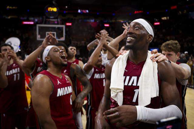 Miami Heat center Bam Adebayo (13) looks up to the sky while celery eating with teammates after he scored 83 points against the Washington Wizards, marking the second-highest single-game point total in NBA history, on Tuesday, March 10, 2026, at Kaseya Center in downtown Miami, Fla. The Miami Heat won 150-129.